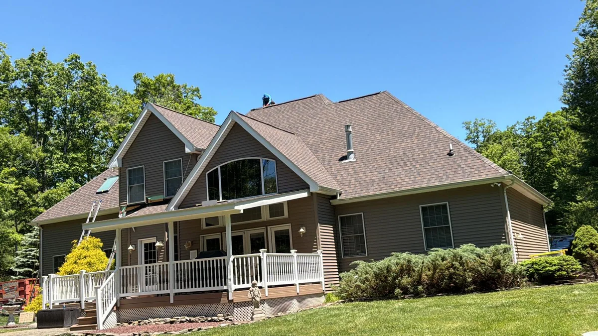 Residential asphalt-shingle roof with roofing work underway, photo supplied by NRG FUTURO